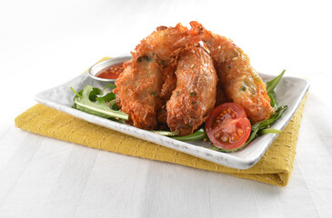 deep fried golden crispy prawn meat ball roll traditional wu Xiang with spicy sauce in white background asian halal snack menu