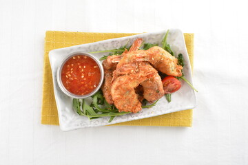 deep fried golden crispy prawn meat ball roll traditional wu Xiang with spicy sauce in white background asian halal snack menu
