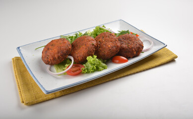 deep fried golden potato cake ball with greens salad in white background asian Indian appetiser halal menu