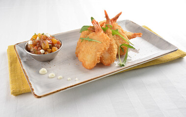 deep fried golden crispy big prawn tempura with small sour salad bowl in white background asian halal snack menu