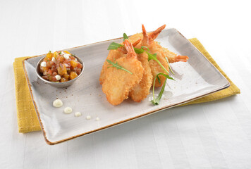 deep fried golden crispy big prawn tempura with small sour salad bowl in white background asian halal snack menu