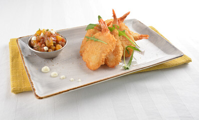 deep fried golden crispy big prawn tempura with small sour salad bowl in white background asian halal snack menu
