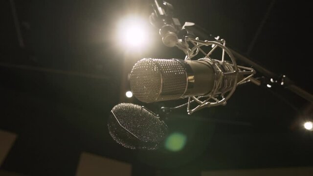 Microphone in a Studio. Suspenden microphone. Golden microfone. low angle shot. flare