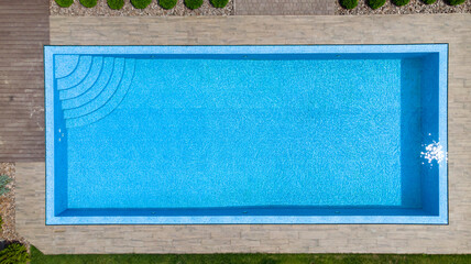 Aerial. Modern luxury pool with staircase. Top view from drone.