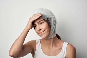 woman holding head bandage injury health medicine