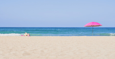 Summer concept. Two umbrellas, beach and blue sea on a beautiful sunny day