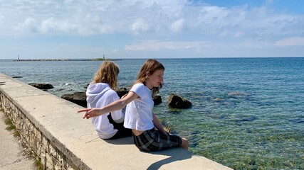 Young girls on vacation by the sea.