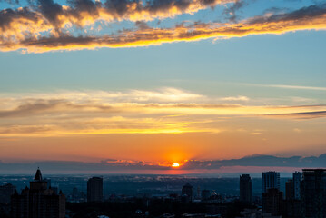 Beautiful sunset over the city in summer 2021