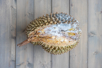 Close up of rotten durian on the this with wooden on the background.