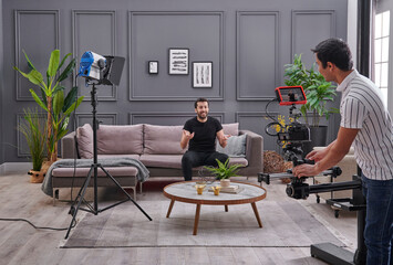 Promotion representative man is taking video at home with high quality light and camera, background style.