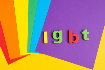 Lettering LGBT. on a colorful rainbow background. Top view