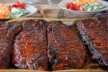 Spare ribs marinated and glazed whole racks on a baking sheet