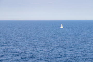 Fototapeta na wymiar Mediterranean sea with a white sailboat