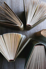 Vintage hardcover books on a wooden table. Top view.