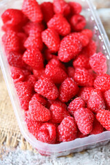 Selective focus. Fresh raspberries in a tray.