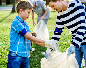 Kids picking up trash in the park