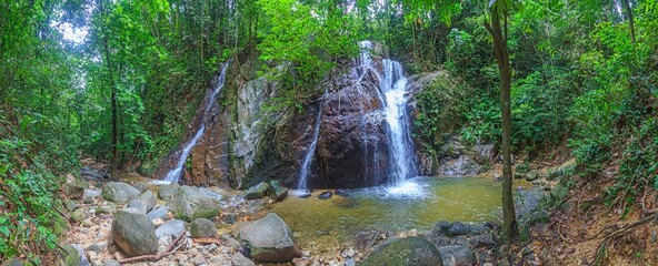 Panoramic view of tropical waterfall in jungle of Malaysia