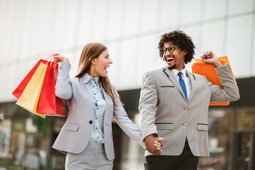 Couple in shopping. Happy couple with shopping bags enjoying in shopping.