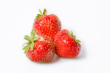 Ripe strawberries on a white background. Sweet red juicy strawberries. Organic food. Copy space. Close up. Seasonal antioxidant and detox nutrient in human health. Top 20 fruits antioxidant capacity