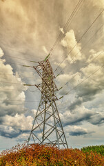 High voltage line and cumulus clouds - 443593940