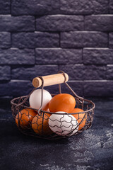 Fototapeta na wymiar Fresh raw eggs in a metal basket.