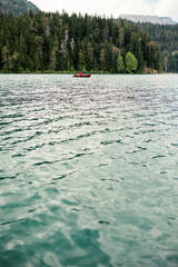 Couple driving wooden boat on a lake