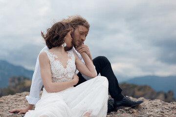 Fototapeta na wymiar brides on the background of mountains and sky