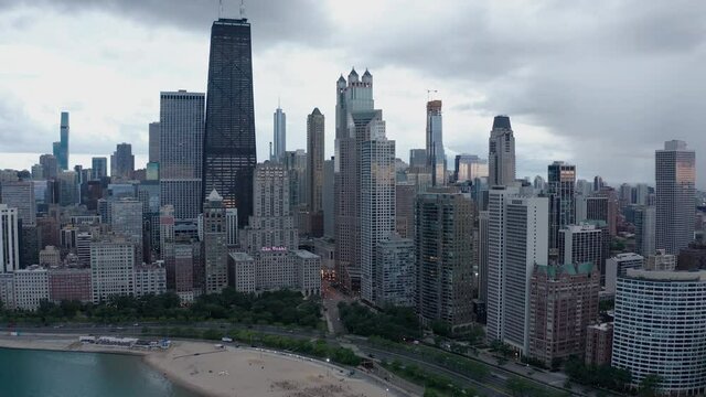Slow aerial pan establishing shot of Chicago's downtown skyline on a cloudy day