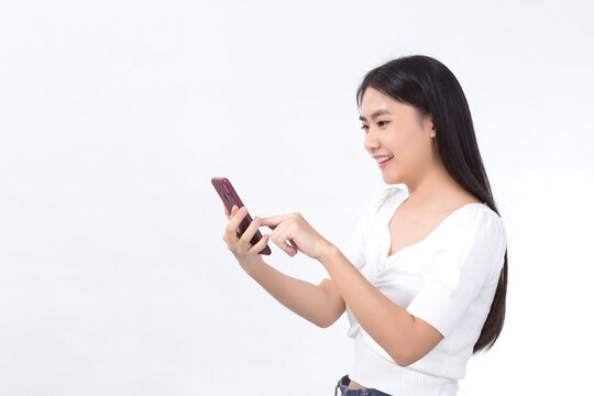 Portrait of beautiful asian girl Use the smartphone happily on a white background