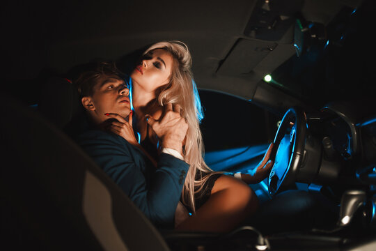 Couple Kissing At Night In The Car. Gentle Night Photo Session In The City. Summer Vacation For Lovers.