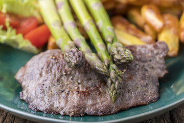 asparagus on a grilled steak