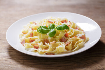 plate of pasta carbonara with basil