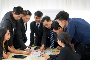 Sales business team in seminar room for make new strategic plan form paper chart on table , brainstorming concept