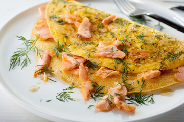 Tasty omelet with fish on plate