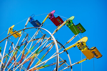 A ferris wheel against a blue sky.