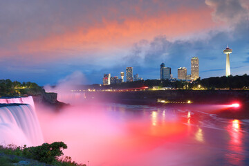 Fototapeta na wymiar Overview of Niagara Falls with beautiful sunset, Niagara Falls is a group of three waterfalls at the southern end of Niagara Gorge, in New York State USA