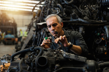 Fototapeta na wymiar Attractive man working hard and fix Auto mechanic on car engine in mechanics garage. Repair service
