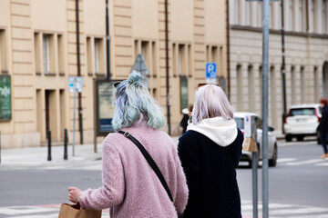 Two Women with colorful Hair walking on the City Streets