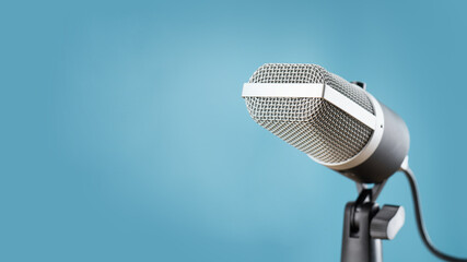 microphone for audio record or Podcast concept, single microphone on soft blue background  with...