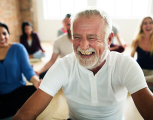 Happy senior man in a yoga class