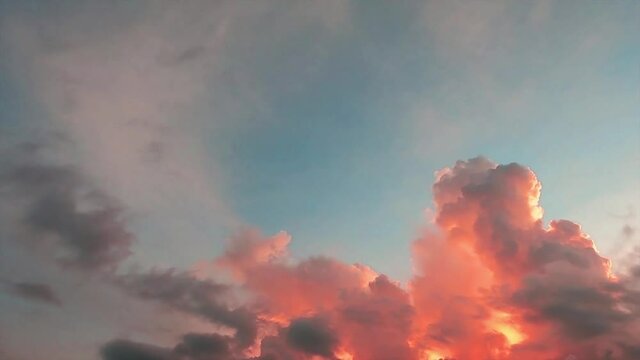 Pastel pink n red sunset clouds on colorful cyan blue sky