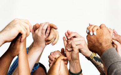 Closeup of diverse people holding hands - Powered by Adobe