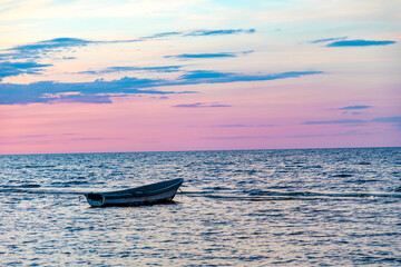 Fototapeta premium Sunset beach in baltic sea with boat