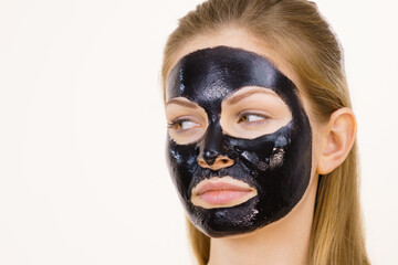 Girl black carbo peel off mask on face
