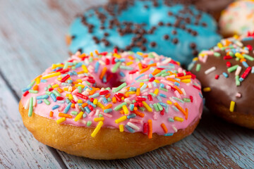 Delicious assorted colorful donuts on the table.