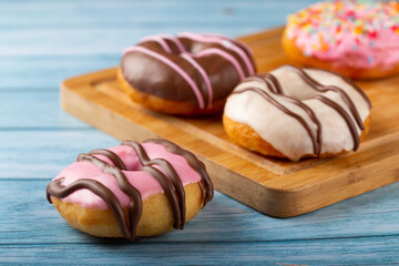 Delicious assorted colorful donuts on the table.