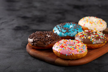 Delicious assorted colorful donuts on the table.