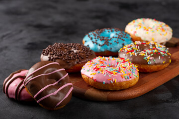 Delicious assorted colorful donuts on the table.
