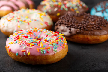 Delicious assorted colorful donuts on the table.