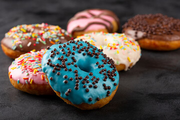 Delicious assorted colorful donuts on the table.